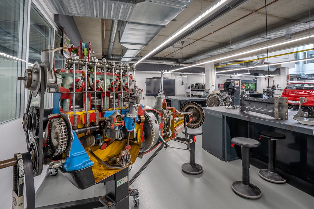 Imagen actual: Interior of a modern workshop featuring detailed automotive machinery and equipment.