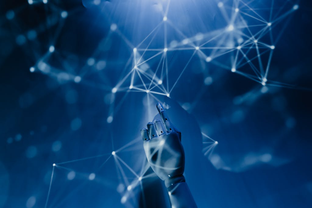 Imagen actual: A robotic hand reaching into a digital network on a blue background, symbolizing AI technology.