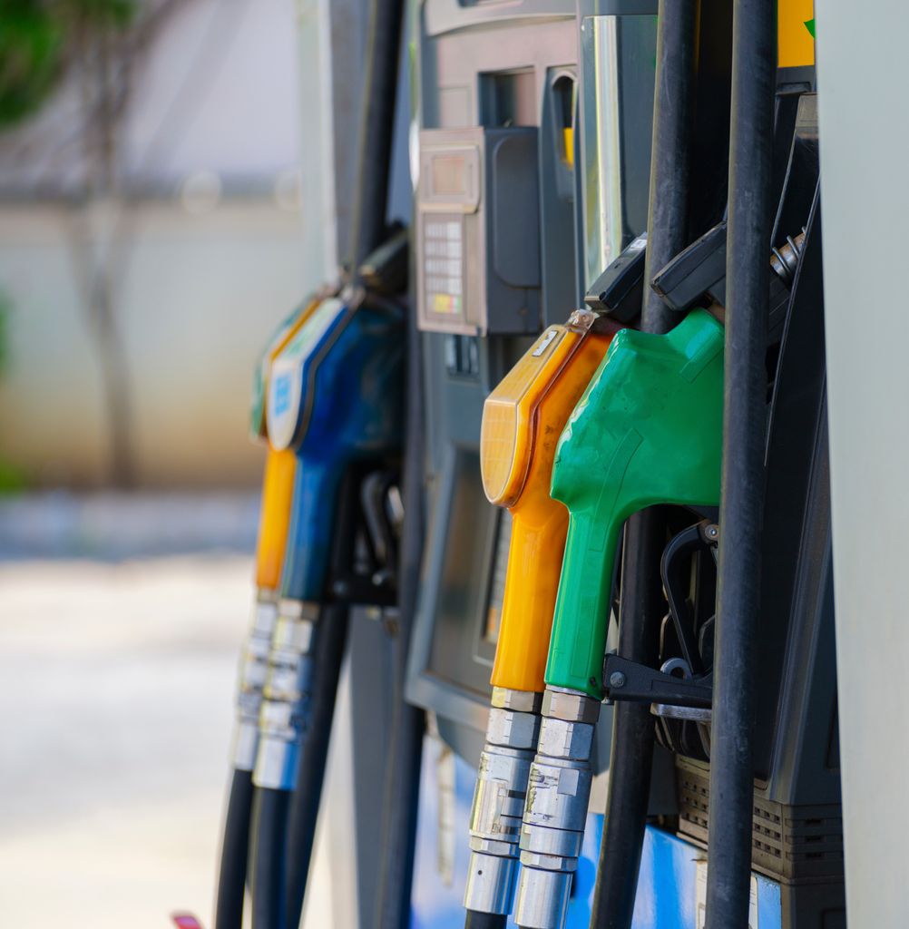 Imagen actual: Close-up of vibrant fuel nozzles at a gasoline station showcasing diesel, gas, and petrol options.